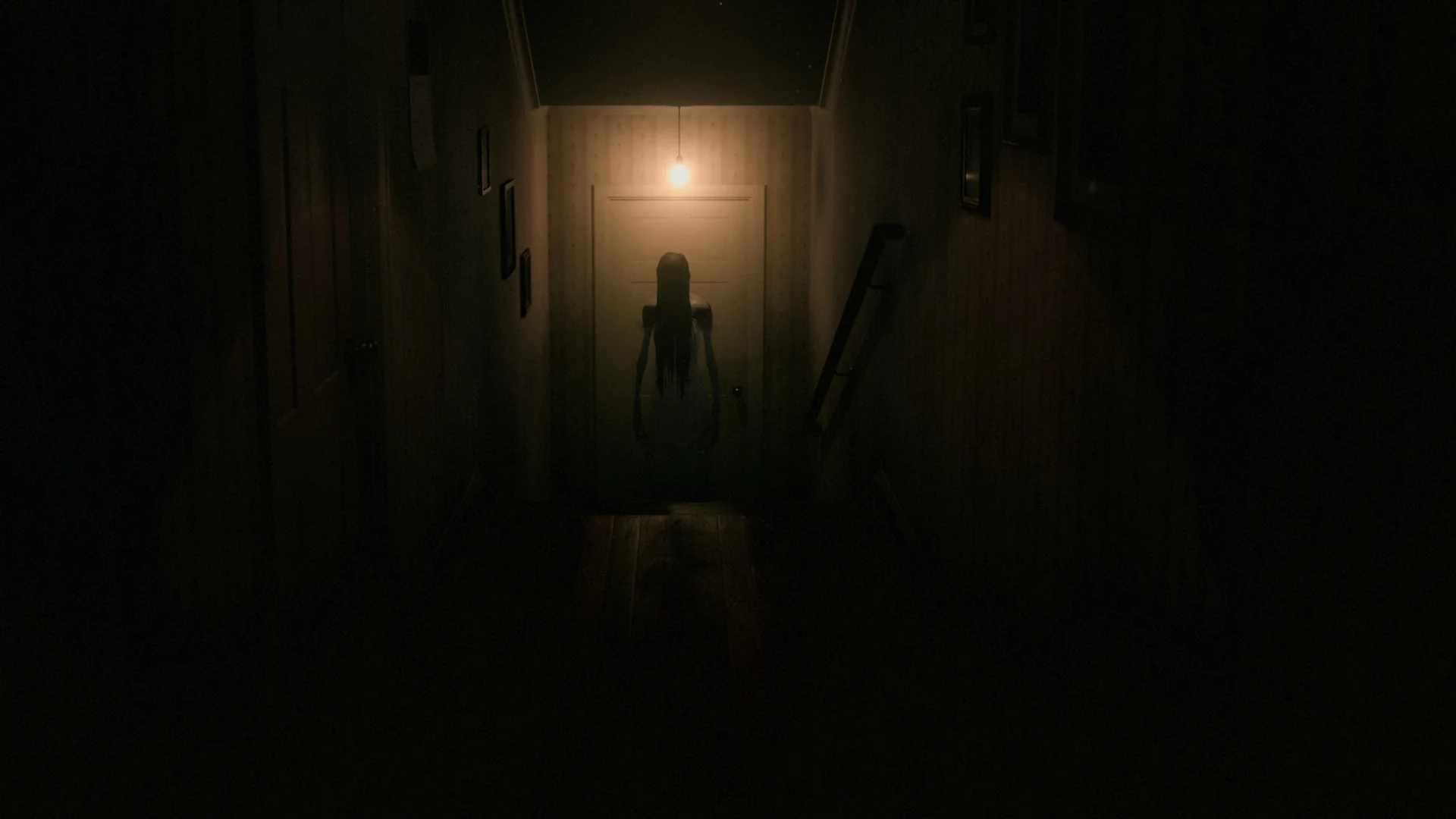 One More Minute: a dark hallway at night. At the far end, under a single bare light bulb, a thin woman stands in front of a closed door, her long hair hiding her face.