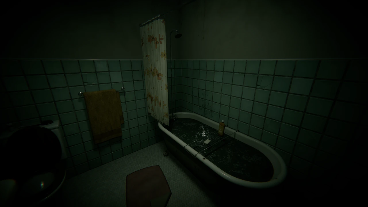 A small green-tiled bathroom; the shower curtain is pulled back and the bathtub is full of black water.