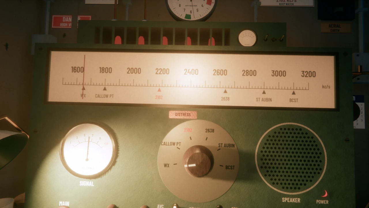 The receiver in a ship's radio room: a lit frequency scale with the distress channel 2182 marked in red, a signal meter, a station dial and a speaker.